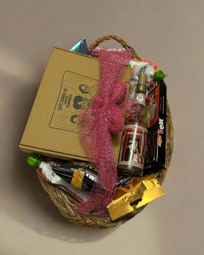 Handmade cane basket filled with premium snacks, including Paper Boat juices, Act II popcorn, and chocolate pies, perfect for post-wedding indulgence.