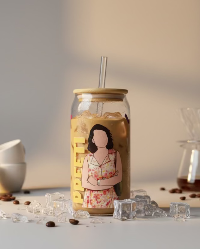 Clear glass tumbler with a printed design on a green cutting mat in a home setting.