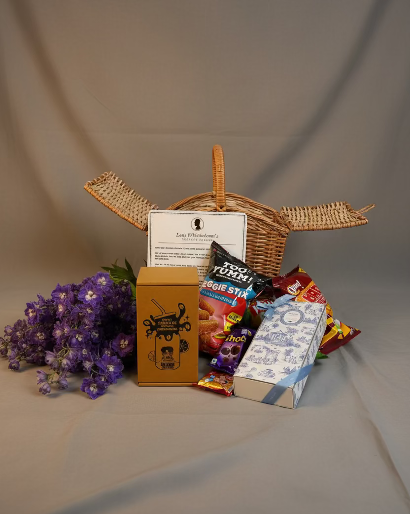 Assorted snacks and a basket on a stone surface with a textured wall background