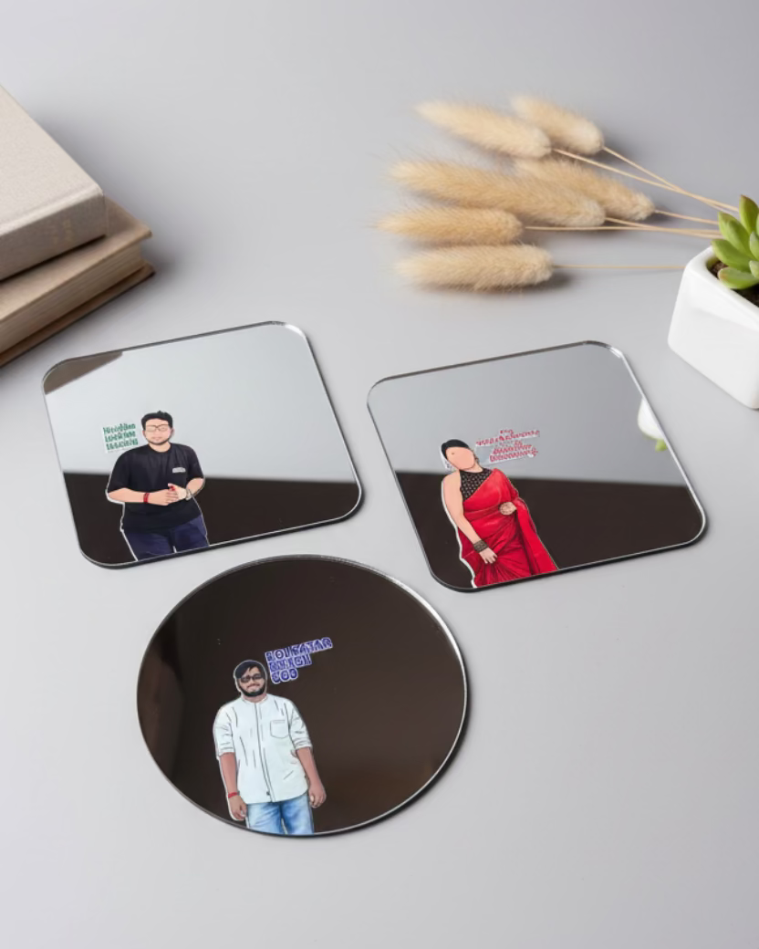 Three reflective mirrors with printed images on a green cutting mat.