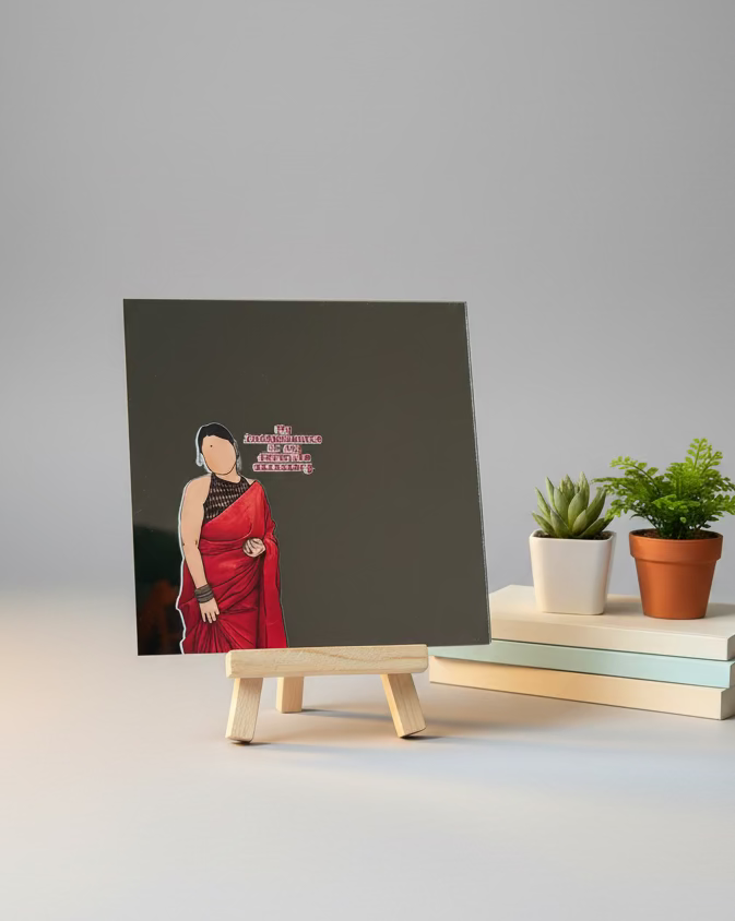 Small portrait of a woman in a red dress on a miniature easel with colorful fabric background